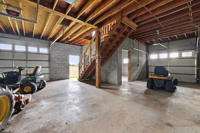 140 Adams Ln, Richmond, KY 40475 - garage featuring a garage door opener and concrete block wall