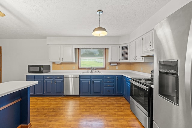 140 Adams Ln, Richmond, KY 40475 - kitchen featuring appliances with stainless steel finishes, blue cabinetry, under cabinet range hood, light wood finished floors, and a sink