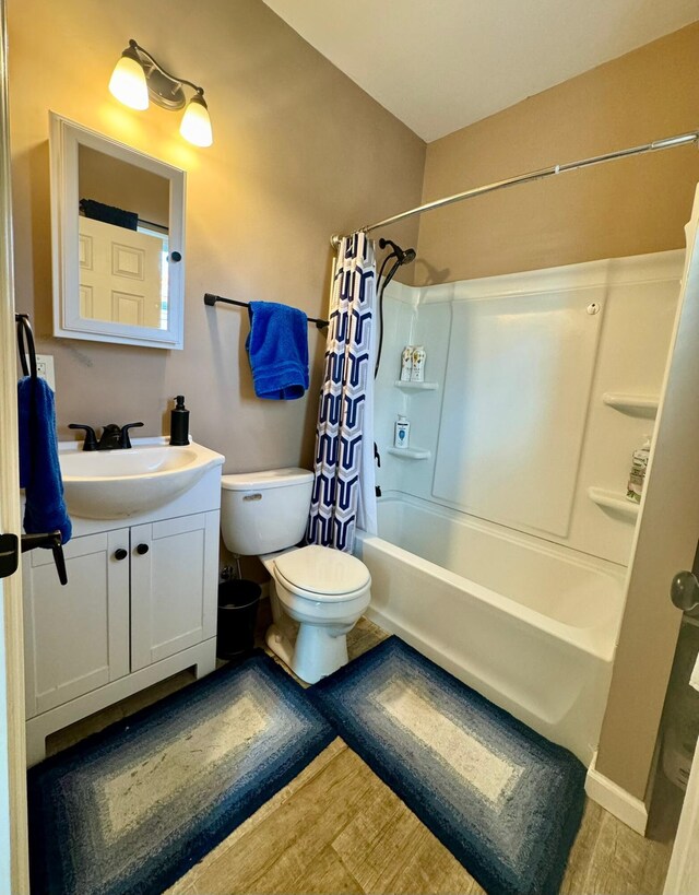 310 W Chestnut St, Nicholasville, KY 40356 - full bathroom featuring toilet, shower / bath combo, vanity, and wood finished floors