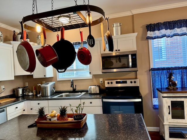 310 W Chestnut St, Nicholasville, KY 40356 - kitchen with appliances with stainless steel finishes, dark countertops, a sink, white cabinets, and crown molding