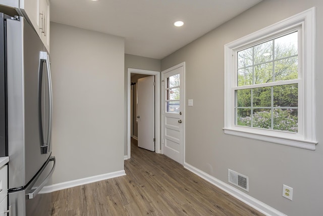 interior space with plenty of natural light, recessed lighting, baseboards, wood finished floors, and visible vents