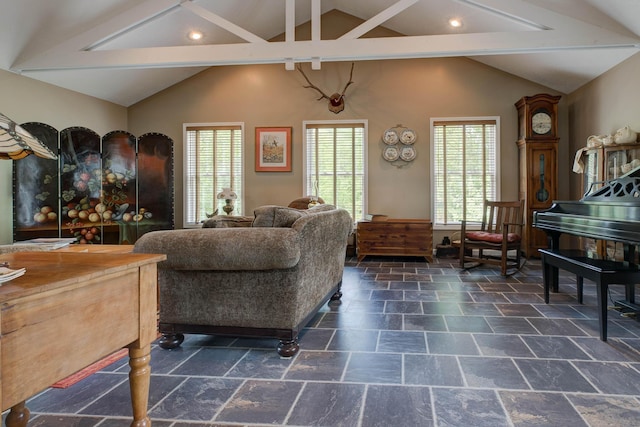 living room with stone tile flooring, lofted ceiling with beams, and recessed lighting