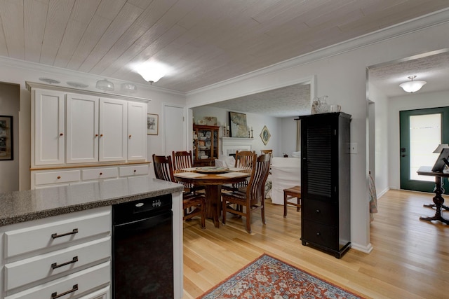 kitchen featuring white cabinets, ornamental molding, and light wood-style floors