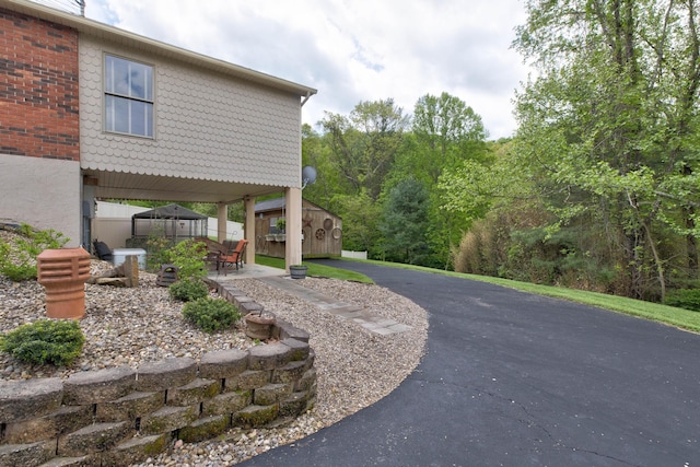 surrounding community featuring a storage shed, fence, an outdoor structure, and a patio area
