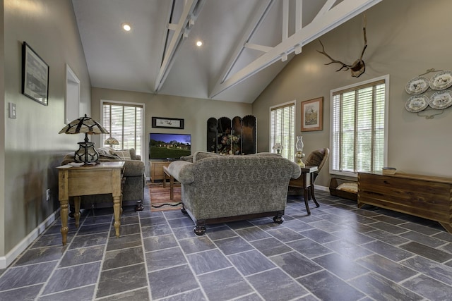 living room with baseboards, high vaulted ceiling, recessed lighting, and stone tile flooring