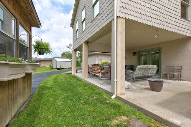 view of yard featuring a patio and french doors