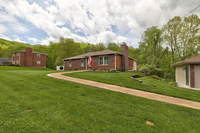 ranch-style home with brick siding, a chimney, and a front lawn