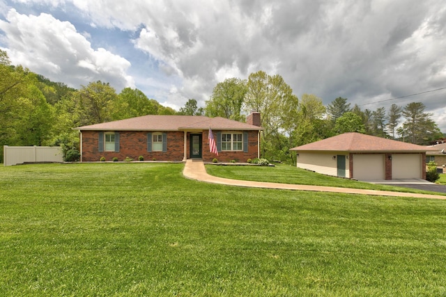 ranch-style house featuring a chimney, a front yard, a detached garage, brick siding, and fence