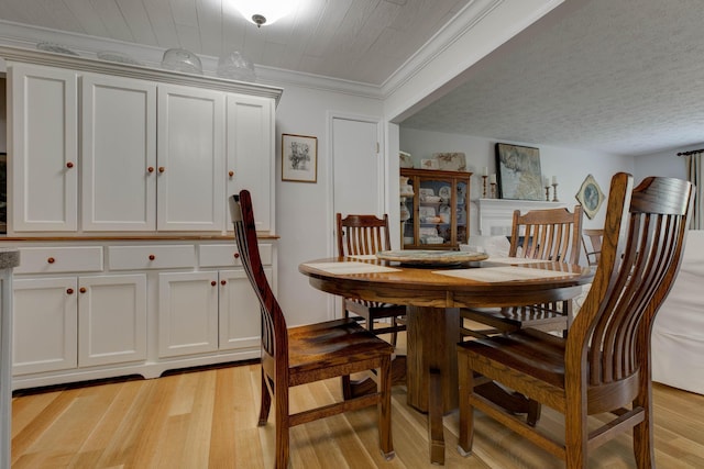 dining area featuring crown molding and light wood-type flooring