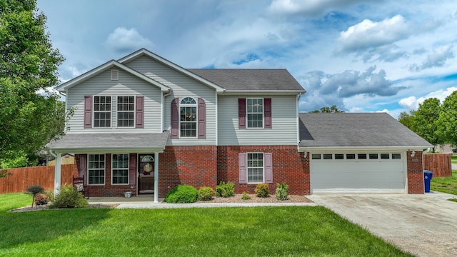 605 Coleman Dr, Berea, KY 40403 - traditional-style house with fence, an attached garage, brick siding, and concrete driveway