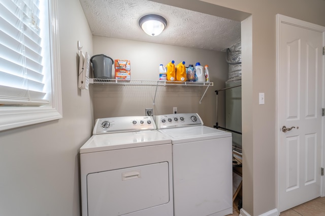 605 Coleman Dr, Berea, KY 40403 - laundry area featuring independent washer and dryer, a textured ceiling, light tile patterned floors, and laundry area