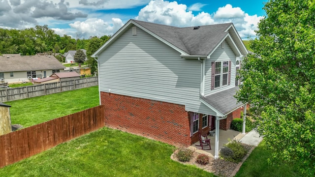 605 Coleman Dr, Berea, KY 40403 - view of home's exterior featuring roof with shingles, a patio area, fence, brick siding, and a yard
