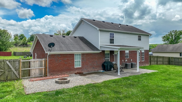 605 Coleman Dr, Berea, KY 40403 - rear view of house with an outdoor fire pit, brick siding, a lawn, and a patio