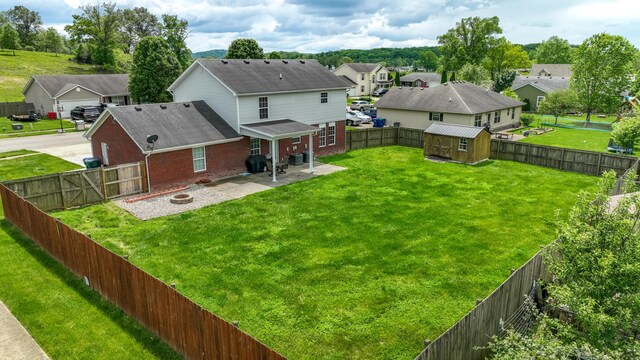 605 Coleman Dr, Berea, KY 40403 - back of house with an outdoor structure, brick siding, a residential view, a patio, and a shed