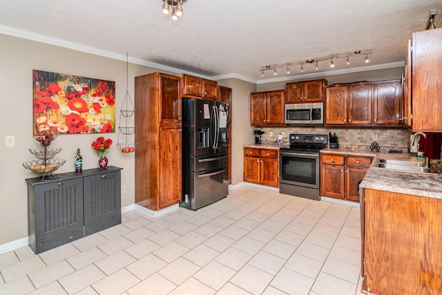 kitchen featuring crown molding, decorative backsplash, light countertops, a sink, and stainless steel appliances
