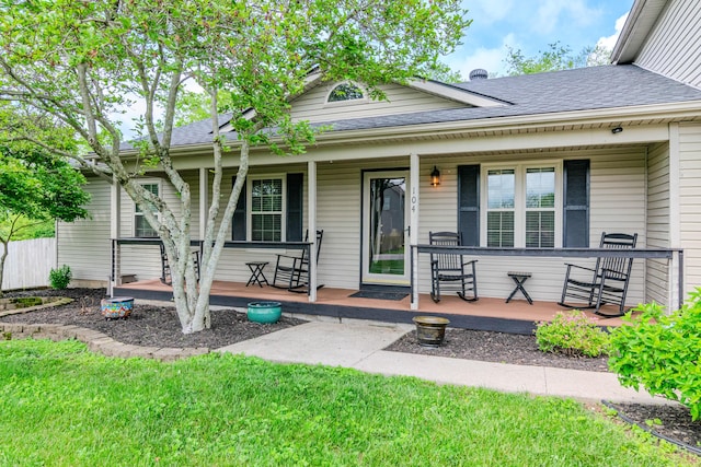 view of front of property featuring a porch and a shingled roof
