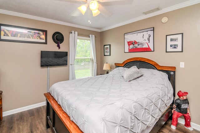 bedroom featuring dark wood-style flooring, baseboards, visible vents, and ornamental molding