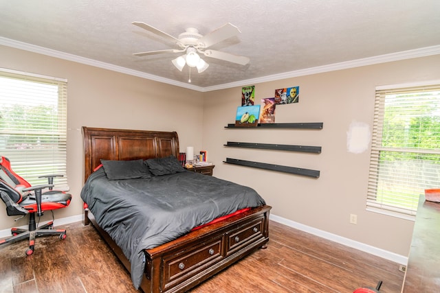bedroom with crown molding, a ceiling fan, baseboards, and wood finished floors