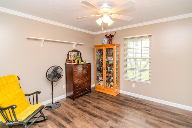 living area with ceiling fan, dark wood-style flooring, visible vents, baseboards, and ornamental molding
