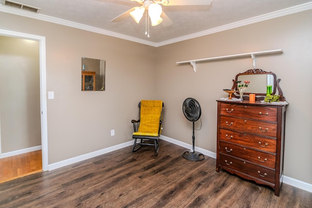 living area featuring crown molding, a ceiling fan, baseboards, wood finished floors, and visible vents