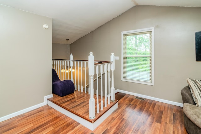 stairs featuring baseboards, visible vents, and wood finished floors