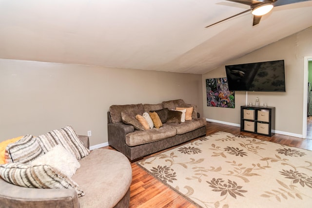 living room with a ceiling fan, baseboards, wood finished floors, and lofted ceiling
