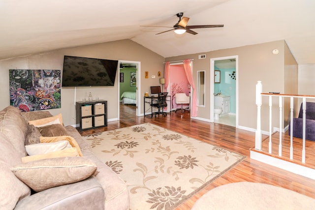 living area with ceiling fan, visible vents, wood finished floors, baseboards, and lofted ceiling