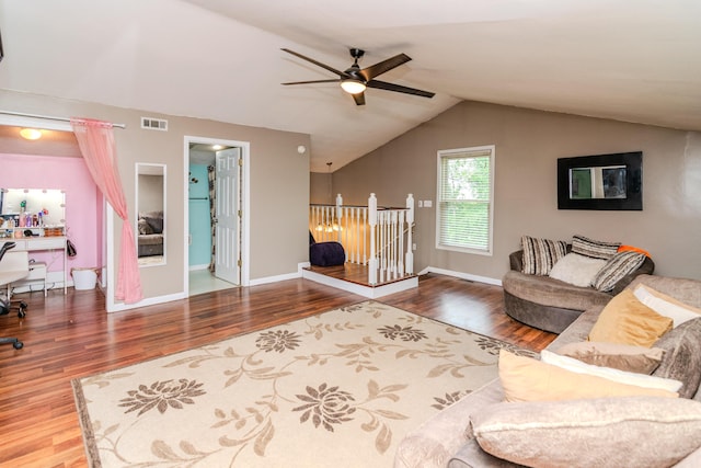 living room with a ceiling fan, baseboards, wood finished floors, vaulted ceiling, and visible vents