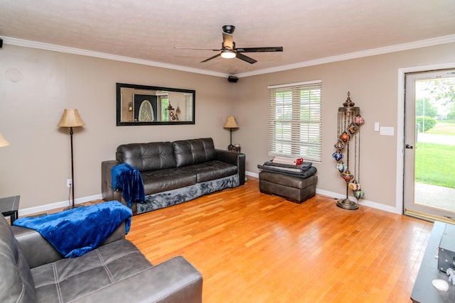 living room with ceiling fan, a wealth of natural light, wood finished floors, and ornamental molding