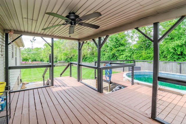 wooden terrace featuring a fenced backyard, a ceiling fan, and a yard