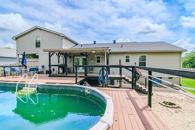 pool featuring a patio, fence, and a deck
