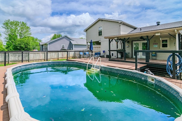 view of pool with a fenced in pool, a fenced backyard, and a deck