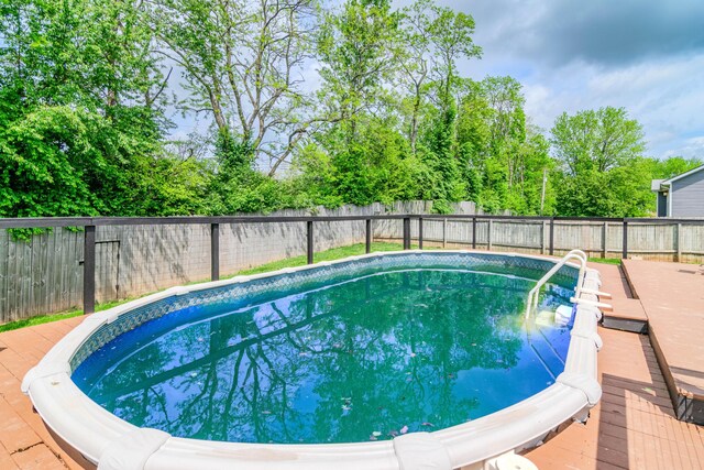 view of pool with a deck, a fenced in pool, and a fenced backyard