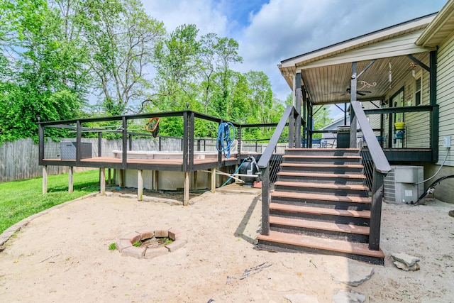 wooden terrace with stairs, ceiling fan, and fence