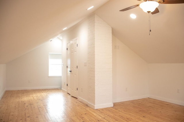 additional living space featuring a ceiling fan, baseboards, recessed lighting, light wood-type flooring, and vaulted ceiling
