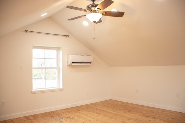 bonus room with baseboards, light wood finished floors, lofted ceiling, and a wall mounted air conditioner