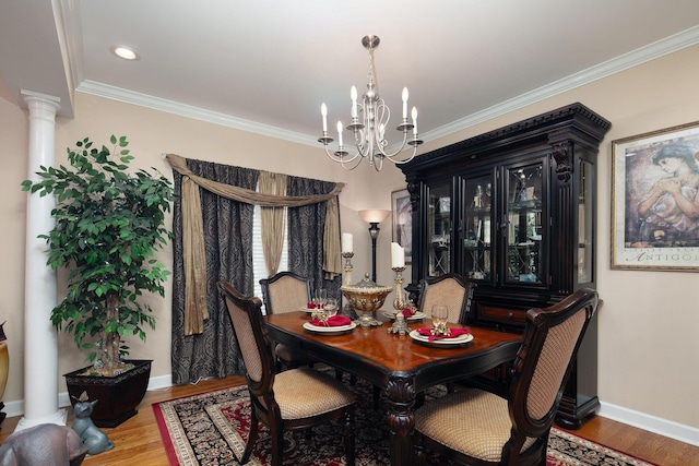 dining room with a chandelier, wood finished floors, decorative columns, ornamental molding, and baseboards