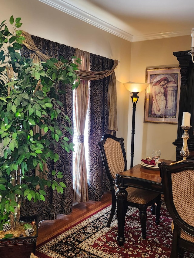 sitting room with wood finished floors and crown molding