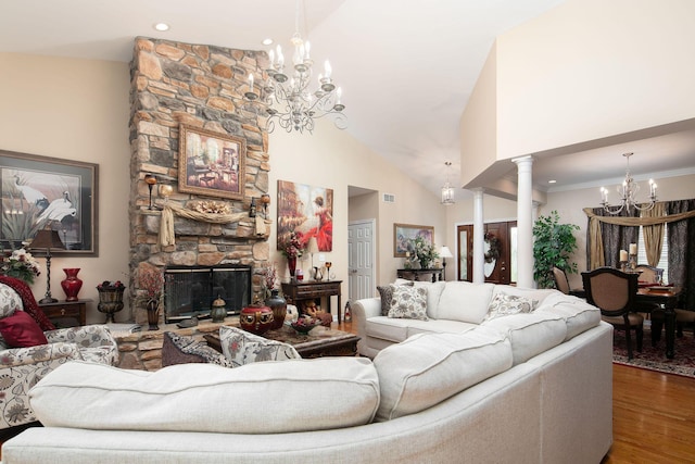 living room featuring a chandelier, decorative columns, wood finished floors, a fireplace, and high vaulted ceiling