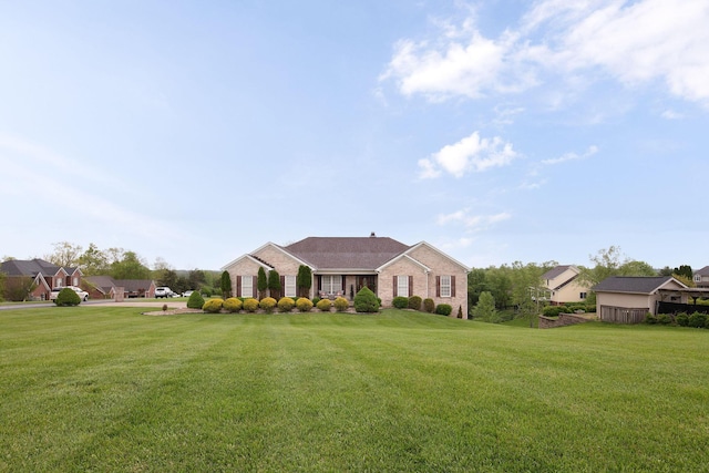 view of front of house with a front lawn and brick siding