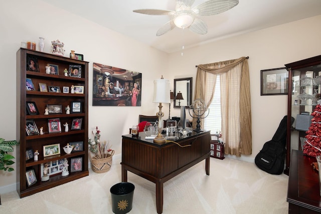carpeted office space with ceiling fan