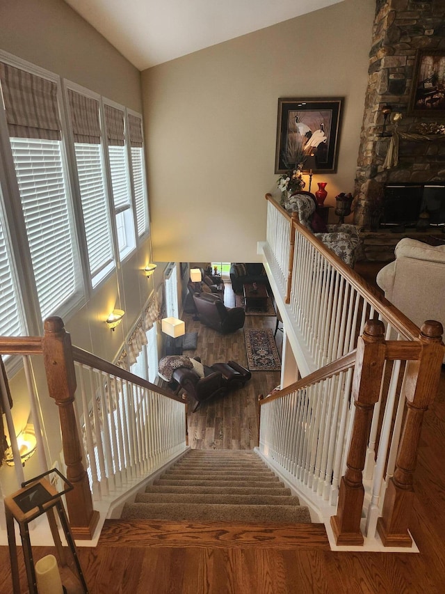 staircase featuring vaulted ceiling and wood finished floors