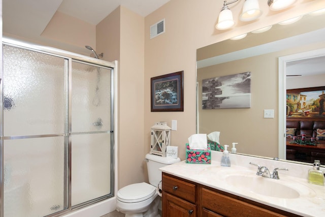 full bath featuring a shower stall, toilet, and vanity