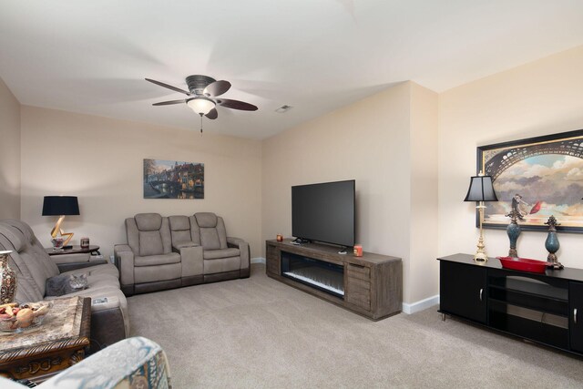 living room with carpet, a ceiling fan, and baseboards
