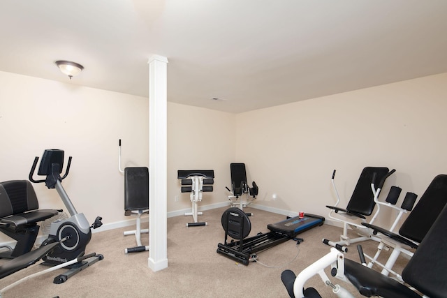 workout area with baseboards, carpet flooring, and ornate columns