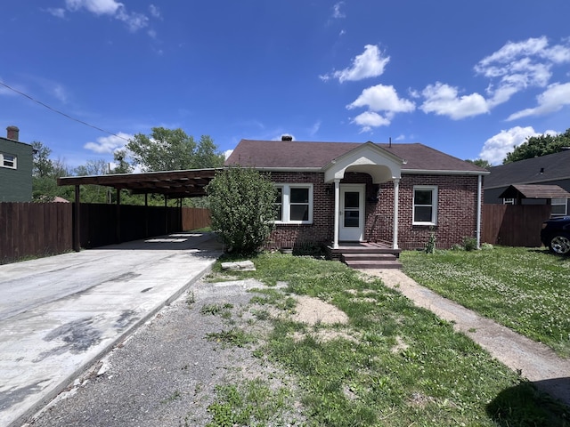 422 Wilderness Rd, Middlesboro, KY 40965 - view of front of property featuring brick siding, concrete driveway, and an attached carport