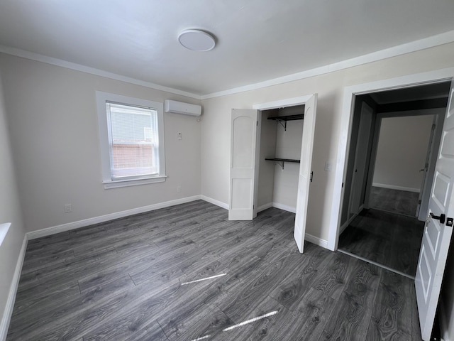 422 Wilderness Rd, Middlesboro, KY 40965 - unfurnished bedroom with dark wood-type flooring, a wall unit AC, a closet, ornamental molding, and baseboards