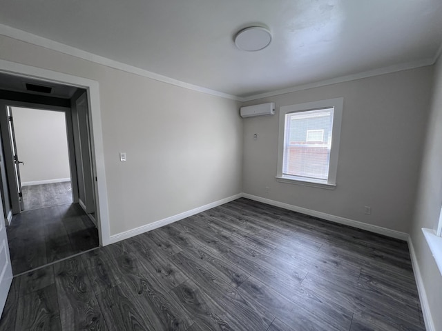 422 Wilderness Rd, Middlesboro, KY 40965 - unfurnished room featuring an AC wall unit, dark wood-type flooring, ornamental molding, and baseboards