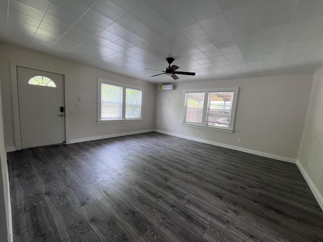 422 Wilderness Rd, Middlesboro, KY 40965 - foyer entrance with dark wood-type flooring, a wall mounted AC, a ceiling fan, and baseboards