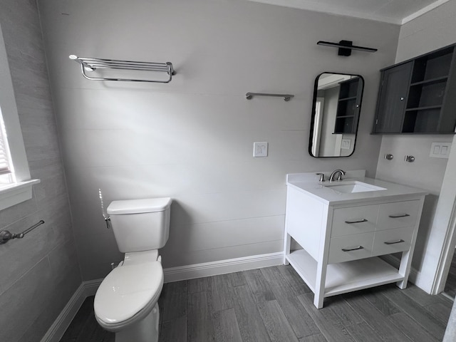 422 Wilderness Rd, Middlesboro, KY 40965 - half bathroom with wood finished floors, toilet, vanity, and baseboards